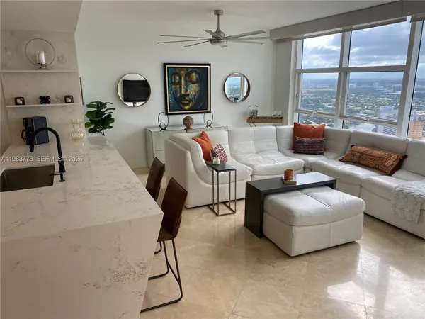 a living room with furniture and a large window