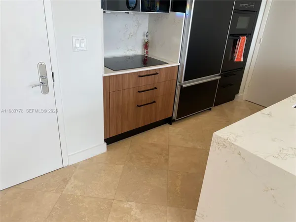 a kitchen with white cabinets and white appliances
