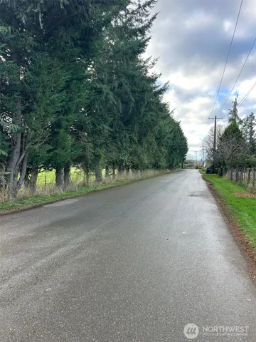 a view of a road with a yard