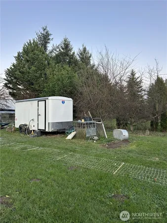 a backyard of a house with table and chairs
