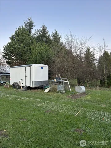 a backyard of a house with table and chairs