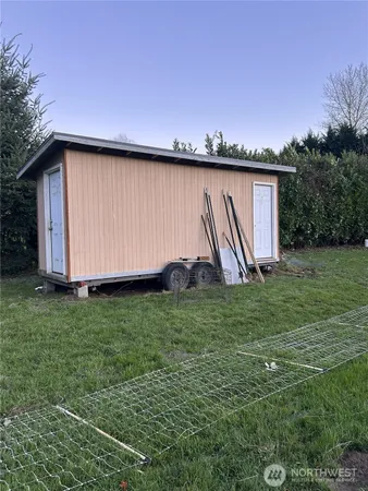 a view of a backyard with potted plants and wooden fence