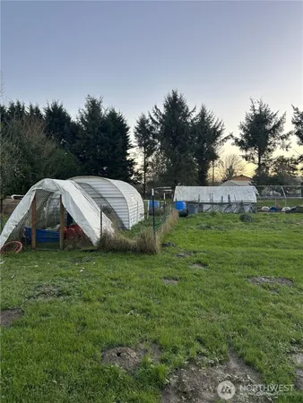 a backyard of a house with table and chairs