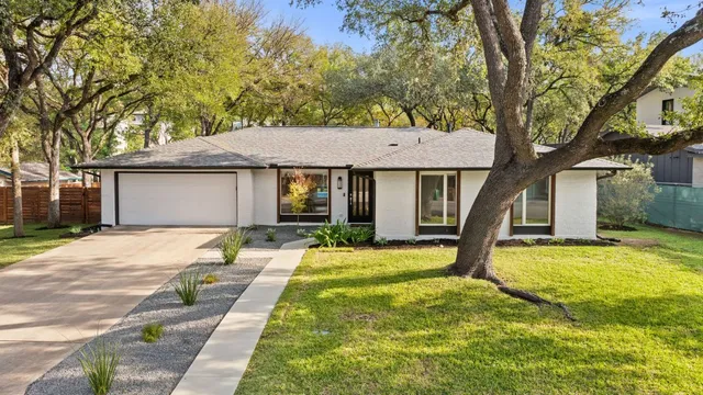 a house that has a tree in front of it