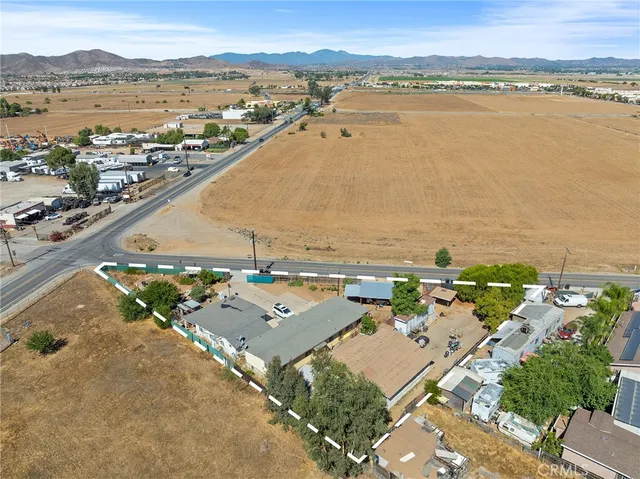 an aerial view of ocean and residential houses with outdoor space