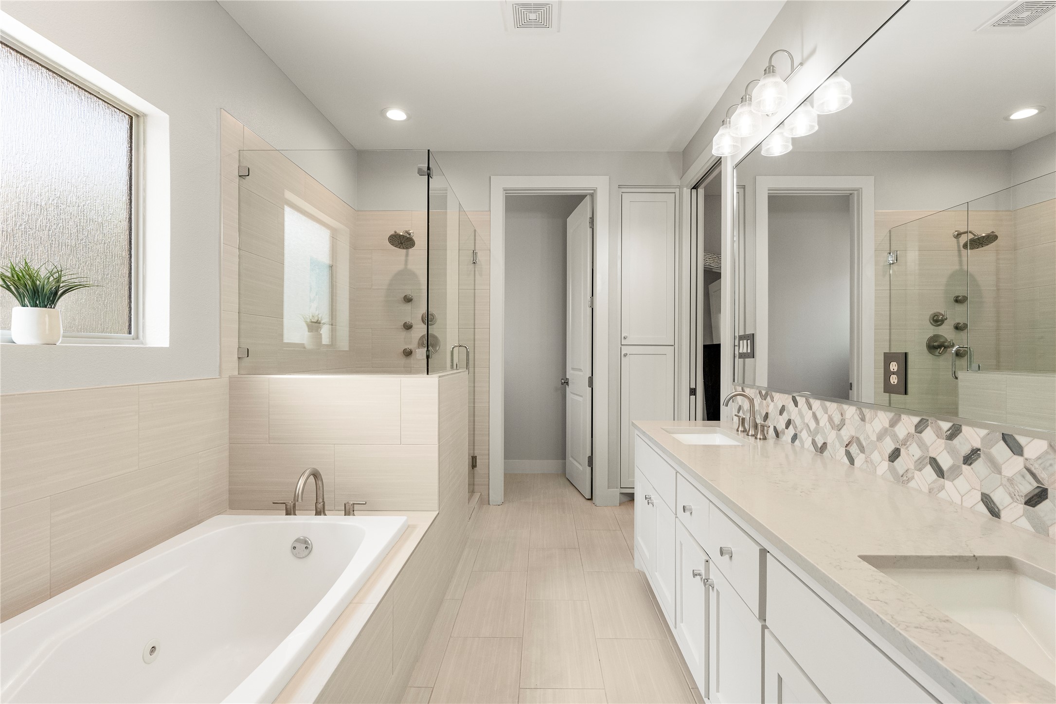3814 Ridgelea Drive, Unit A Austin, TX 78731 - Photo 23 of 30 a bathroom with a bathtub a sink and a large mirror