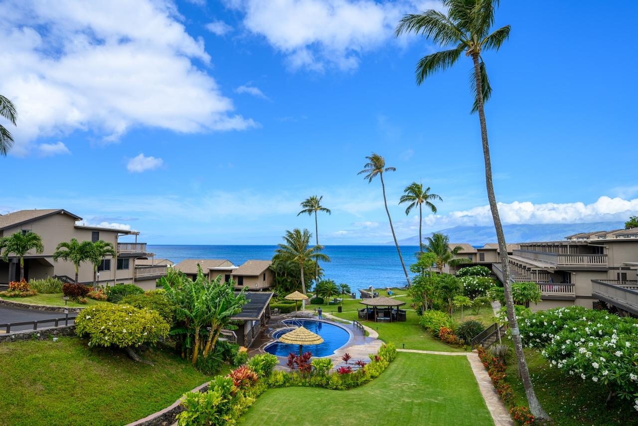 4909 Lower Honoapiilani Road, Unit D6 Lahaina, HI 96761 - Photo 1 of 47 a front view of a house with a yard and potted plants