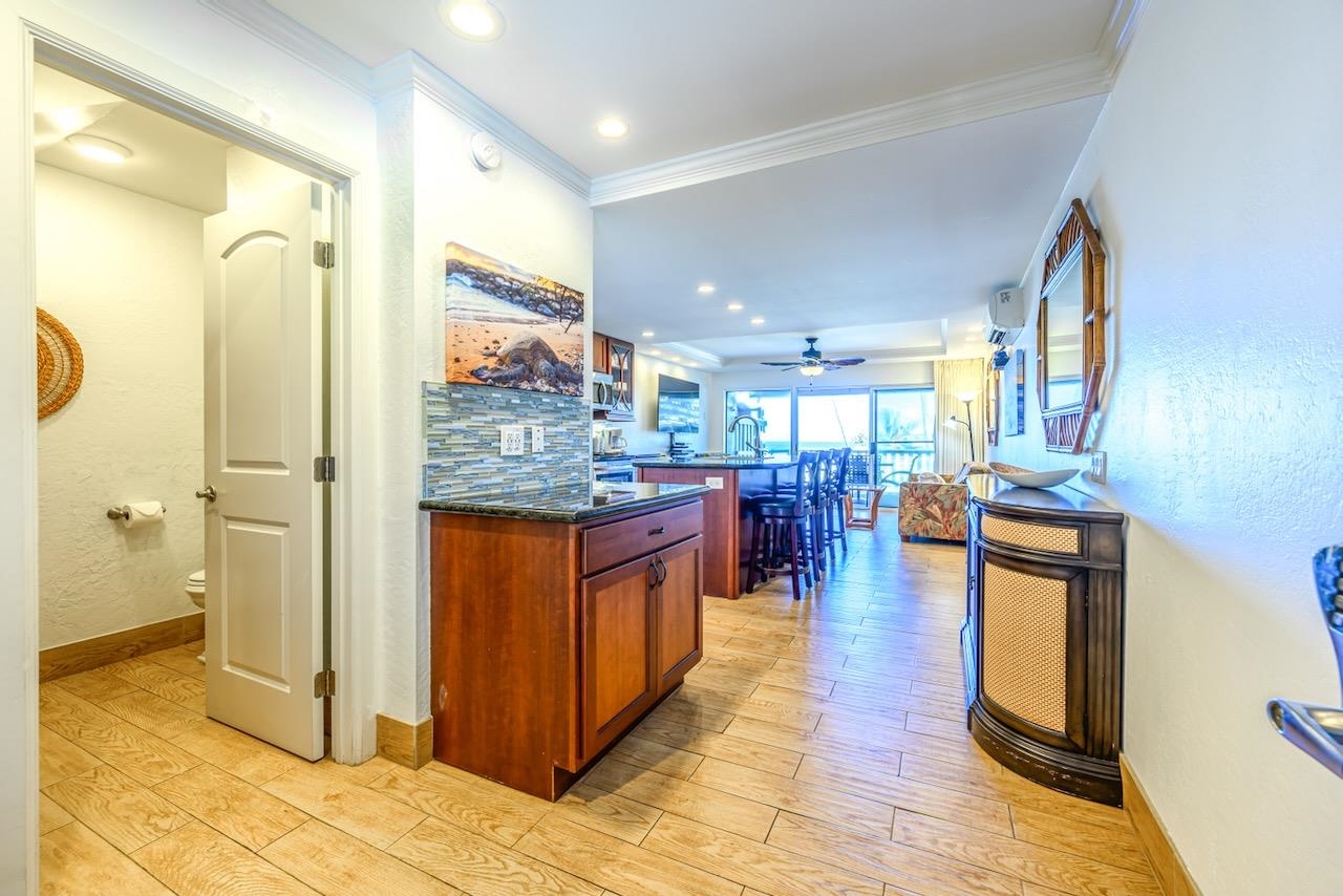 4909 Lower Honoapiilani Road, Unit D6 Lahaina, HI 96761 - Photo 12 of 47 a kitchen with stainless steel appliances granite countertop a refrigerator and a stove