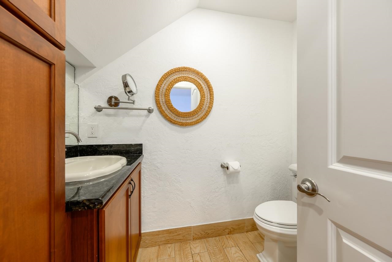 4909 Lower Honoapiilani Road, Unit D6 Lahaina, HI 96761 - Photo 13 of 47 a bathroom with a sink a toilet and a mirror