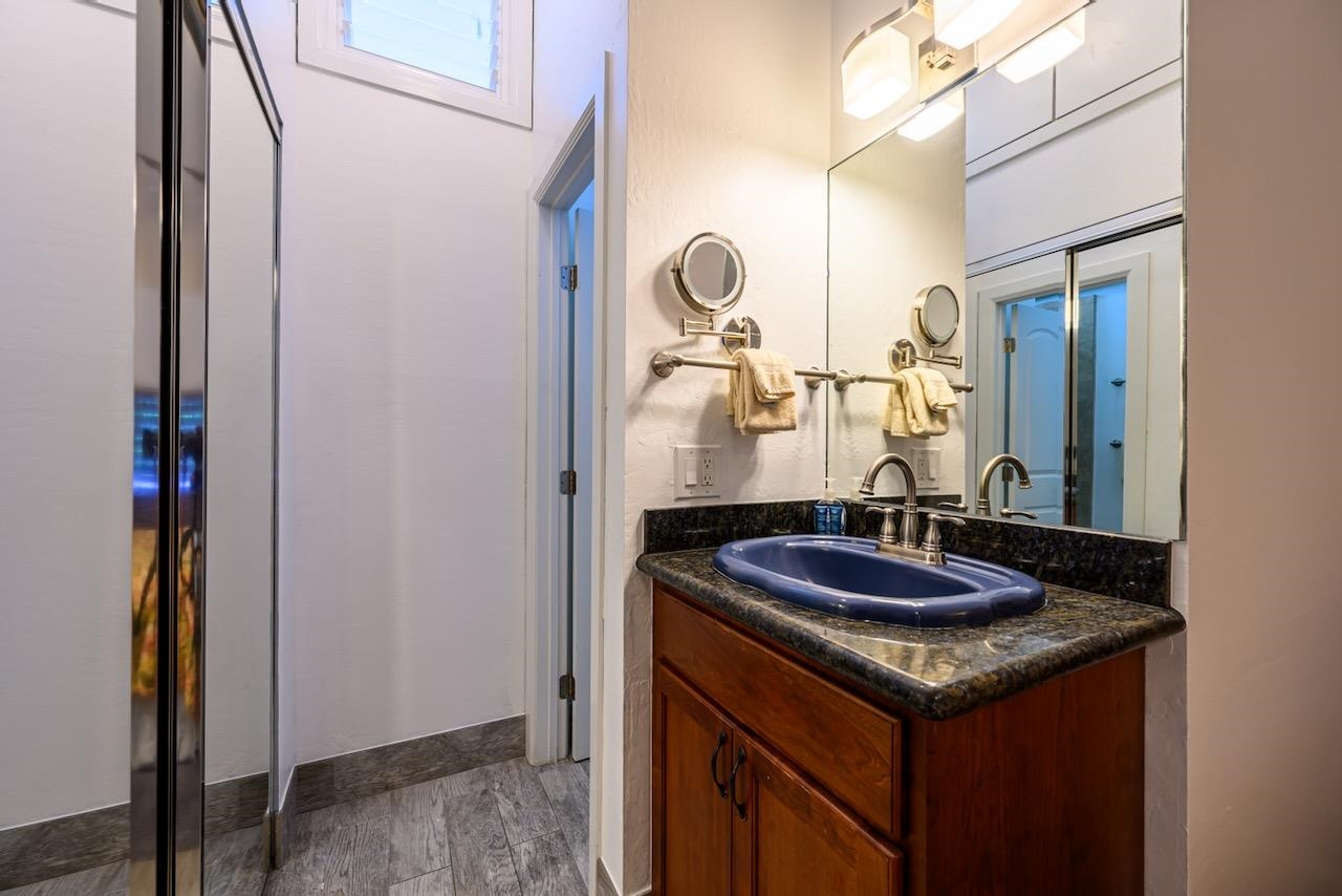 4909 Lower Honoapiilani Road, Unit D6 Lahaina, HI 96761 - Photo 15 of 47 a bathroom with a granite countertop sink and a mirror