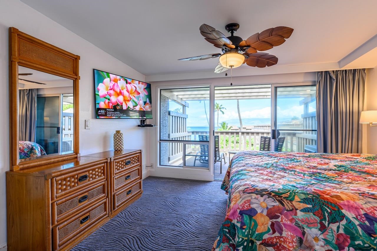 4909 Lower Honoapiilani Road, Unit D6 Lahaina, HI 96761 - Photo 22 of 47 a bedroom with a bed and furniture with outer view