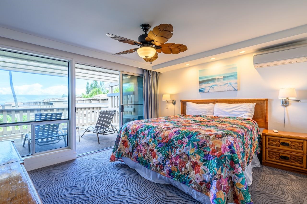 4909 Lower Honoapiilani Road, Unit D6 Lahaina, HI 96761 - Photo 23 of 47 a bedroom with a bed and wooden floor