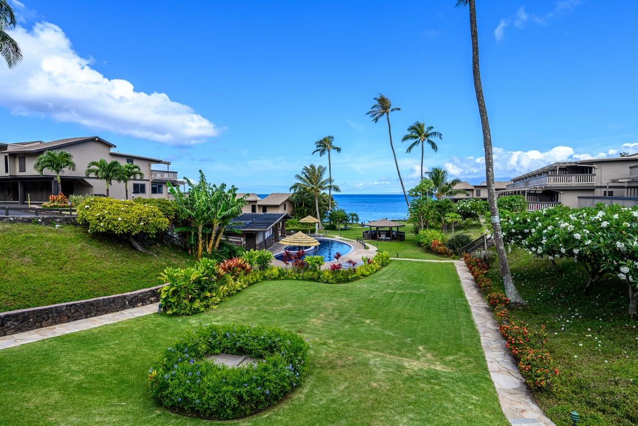 4909 Lower Honoapiilani Road, Unit D6 Lahaina, HI 96761 - Photo 32 of 47 a view of a garden with a building in the background