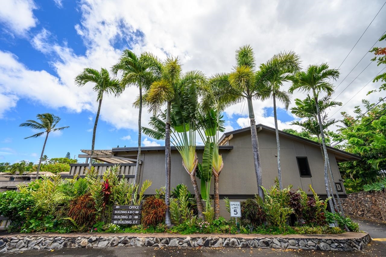 4909 Lower Honoapiilani Road, Unit D6 Lahaina, HI 96761 - Photo 34 of 47 a front view of a house with a yard and potted plants