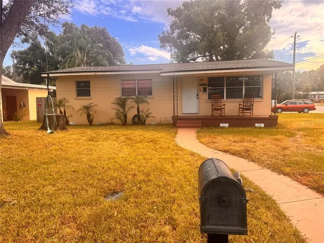 a swimming pool with outdoor seating and yard