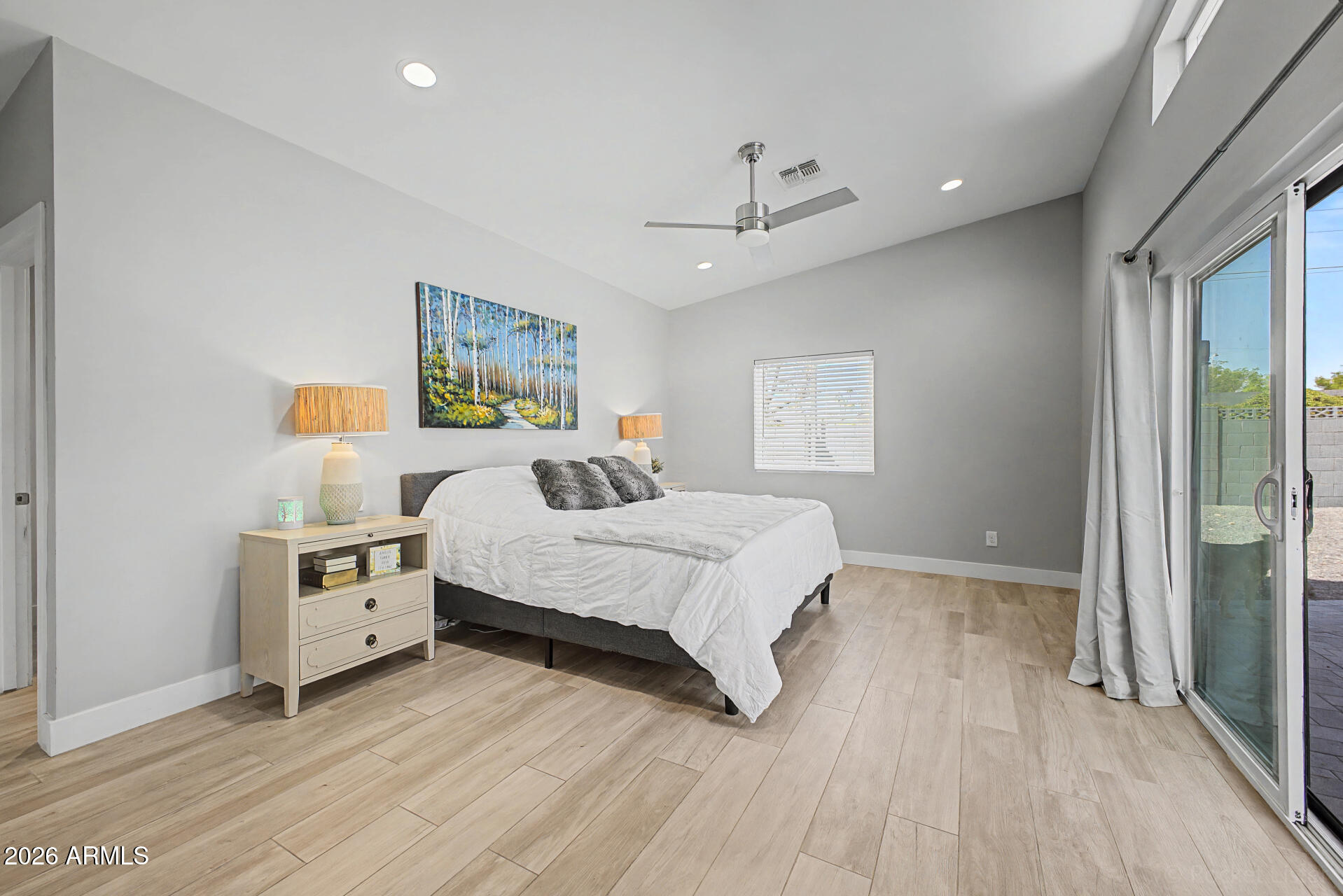 1930 East Rovey Avenue Phoenix, AZ 85016 - Photo 11 of 29 a spacious bedroom with a bed and a painting on the wall