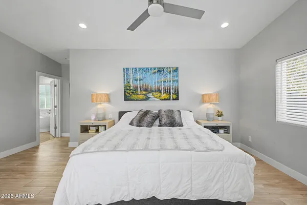 a bathroom with a tub a double vanity sink and a large mirror