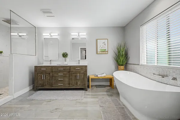 a spacious bathroom with a double vanity sink shower and a mirror