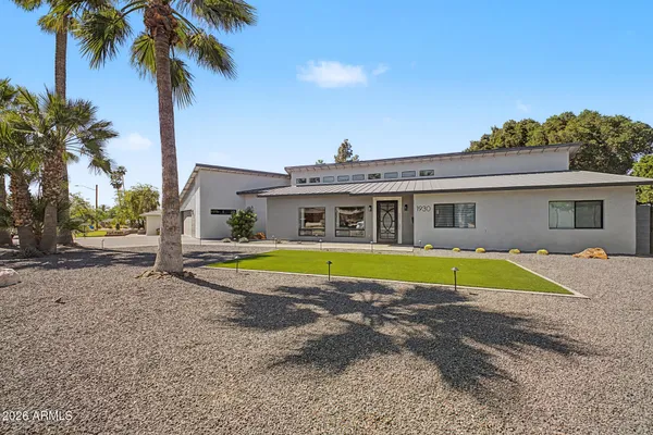 a living room with furniture kitchen view and a chandelier