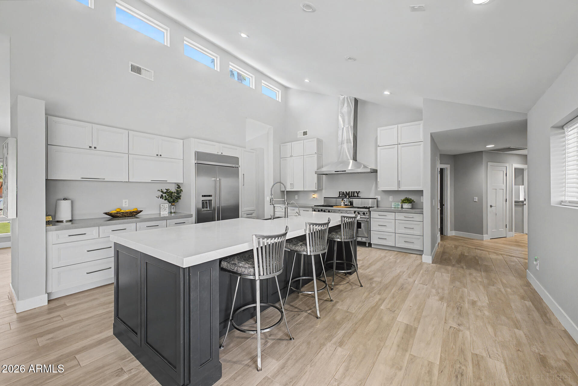 1930 East Rovey Avenue Phoenix, AZ 85016 - Photo 8 of 29 a kitchen with white cabinets and stainless steel appliances