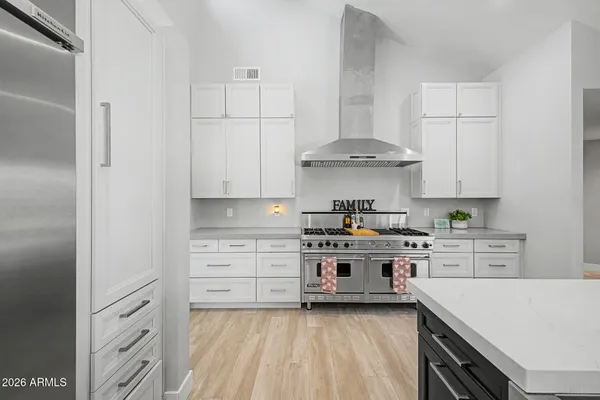 a kitchen with stainless steel appliances granite countertop a stove and a cabinets