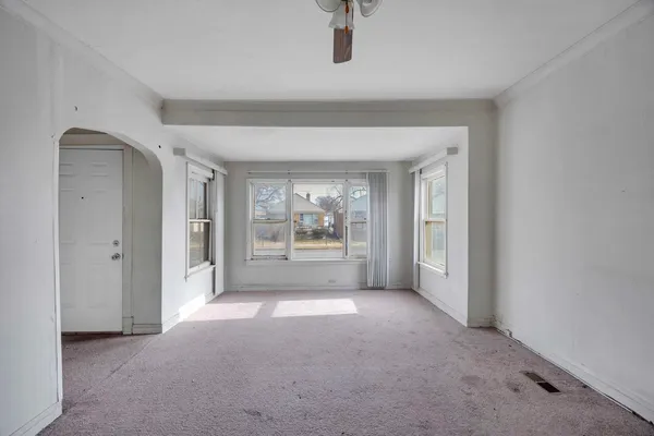 a view of a big room with closet and a ceiling fan