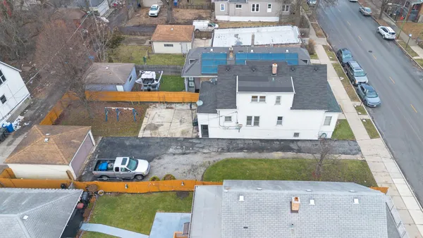 an aerial view of a house with yard swimming pool and outdoor seating