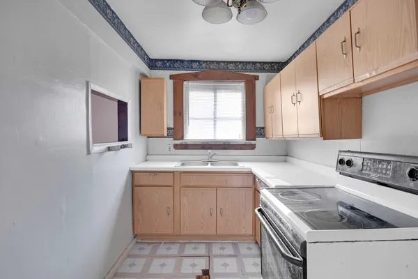a kitchen with a sink stove and cabinets