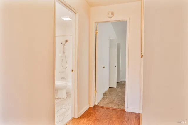 a view of a bathroom from a hallway