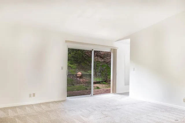 an empty room with floor to ceiling window