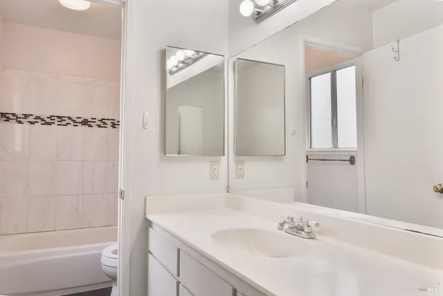 a bathroom with a bathtub shower sink and toilet