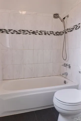 a bathroom with a white bath tub and a shower