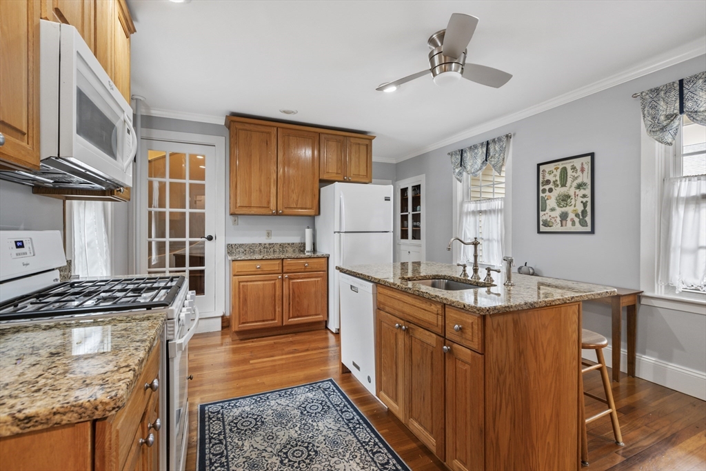 26 Maple Street Taunton, MA 02780 - Photo 12 of 31 a kitchen with sink a stove and chairs