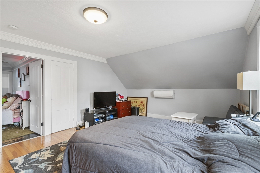 26 Maple Street Taunton, MA 02780 - Photo 22 of 31 a bedroom with a bed and a flat tv screen on dresser