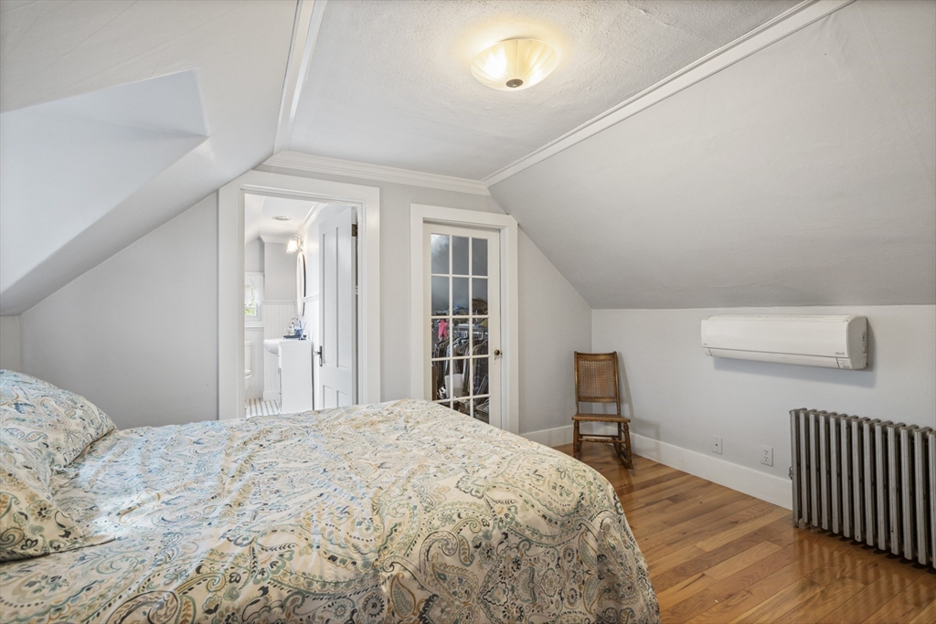 26 Maple Street Taunton, MA 02780 - Photo 29 of 31 a bedroom with a large bed and wooden floor