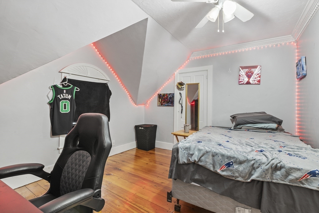 26 Maple Street Taunton, MA 02780 - Photo 30 of 31 a bedroom with a bed and wooden floor