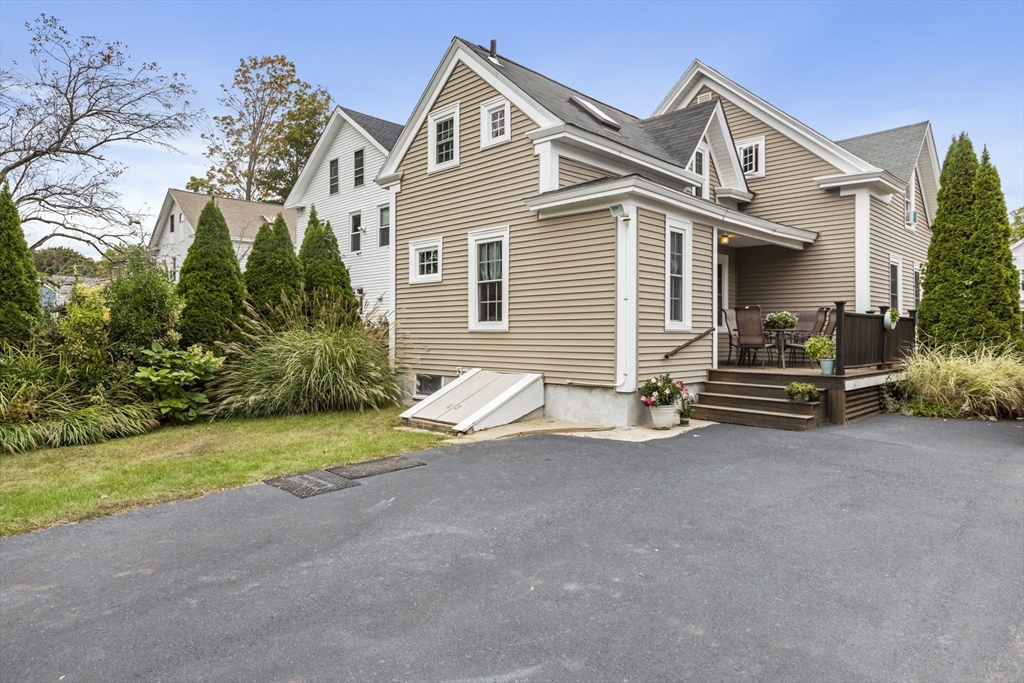 26 Maple Street Taunton, MA 02780 - Photo 5 of 31 a view of a house with a yard and garage