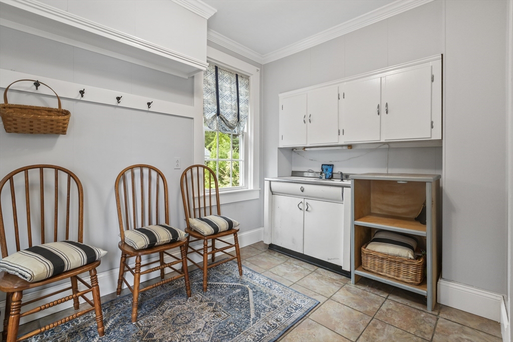 26 Maple Street Taunton, MA 02780 - Photo 8 of 31 a kitchen with a table chairs and a refrigerator