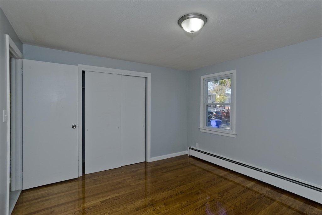 37 Wilber Street Springfield, MA 01104 - Photo 15 of 27 an empty room with wooden floor and windows