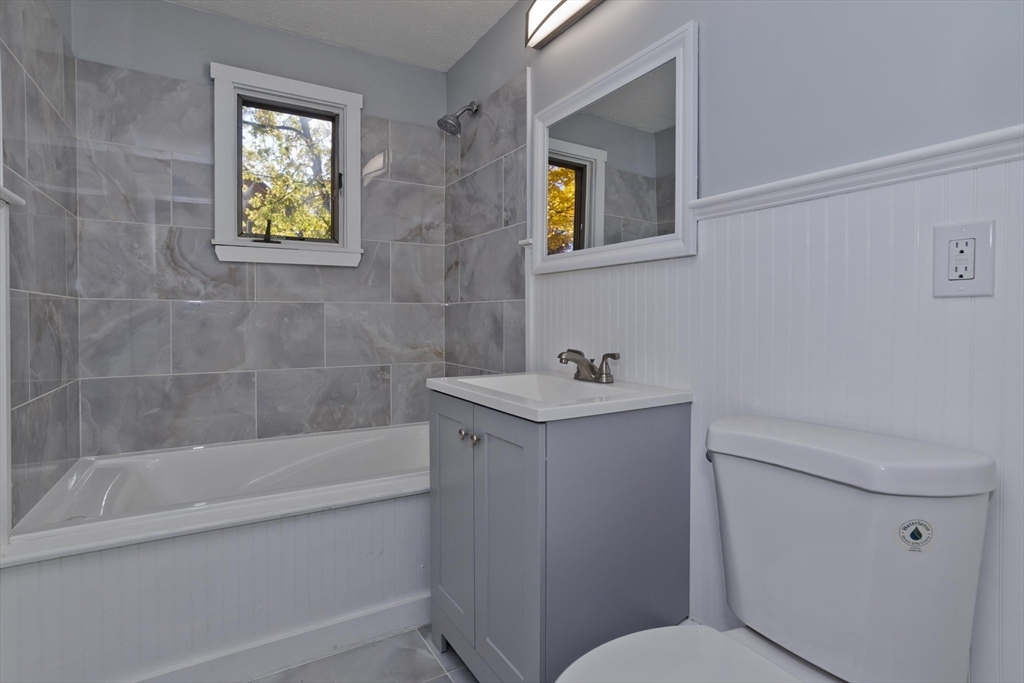 37 Wilber Street Springfield, MA 01104 - Photo 21 of 27 a bathroom with a sink mirror vanity and toilet