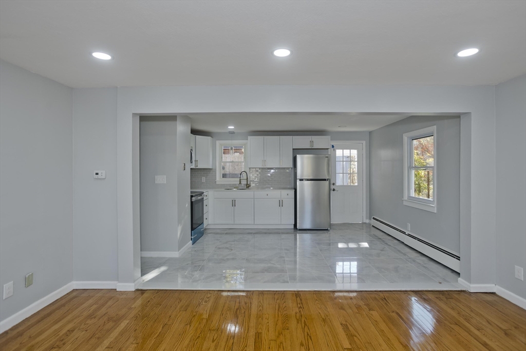 37 Wilber Street Springfield, MA 01104 - Photo 4 of 27 a view of a kitchen with wooden floor and a sink
