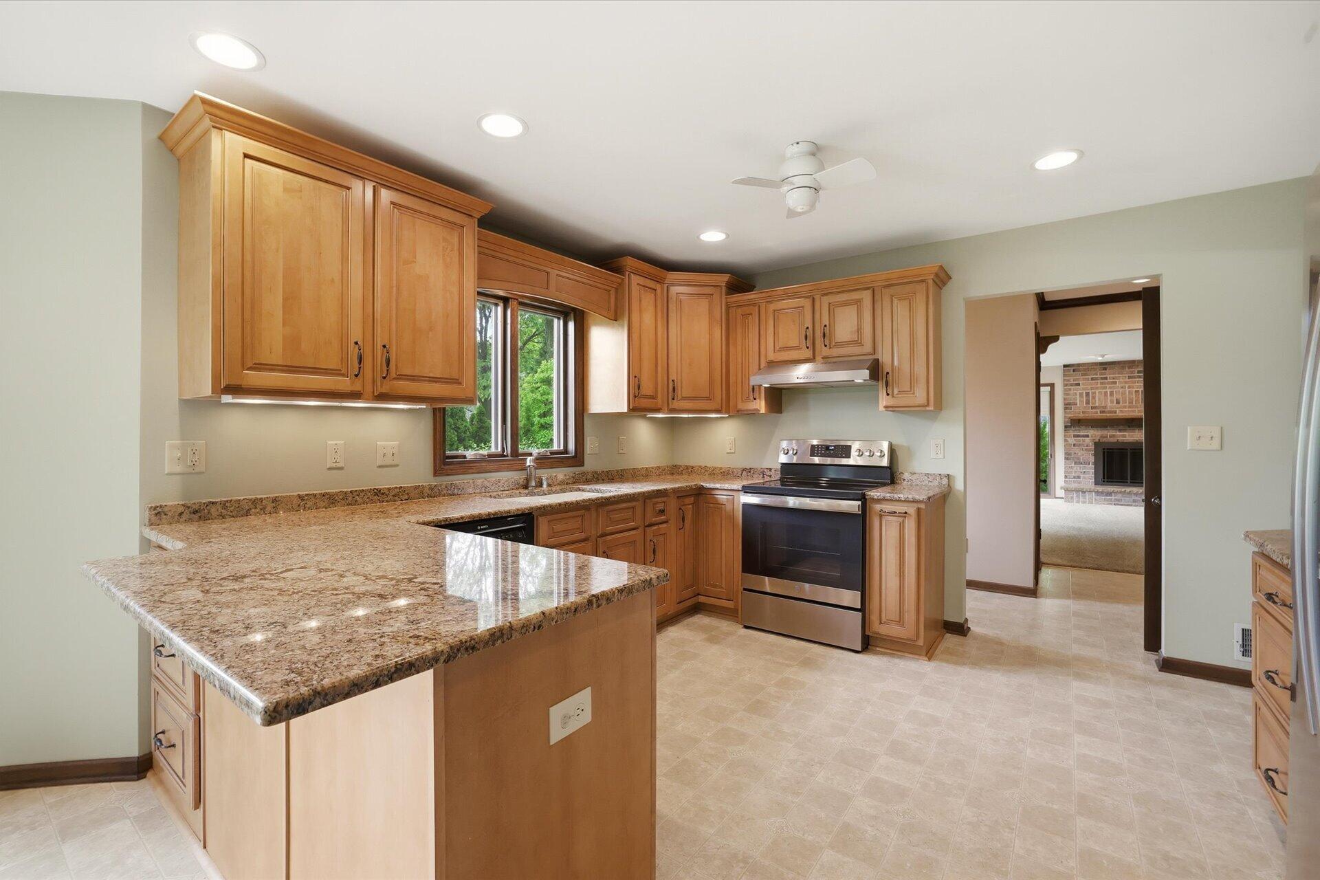 4100 South 119th Street Greenfield, WI 53228 - Photo 4 of 31 Kitchen by AB&K with granite tops and under cabinetry lighting! Just beautiful!