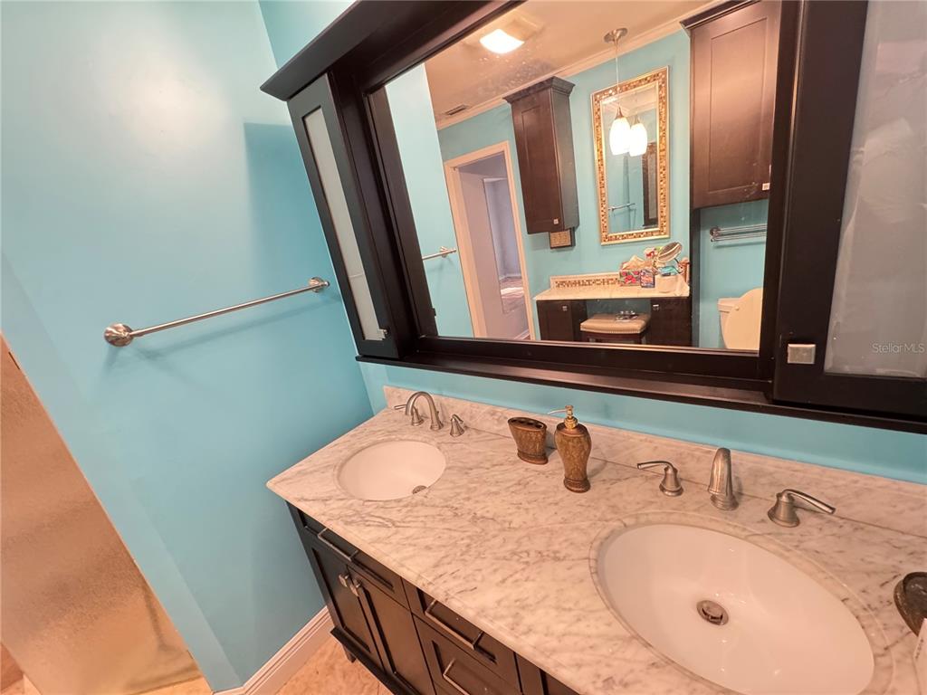6286 Southwest 110th Street Ocala, FL 34476 - Photo 7 of 14 a bathroom with a granite countertop sink and a mirror