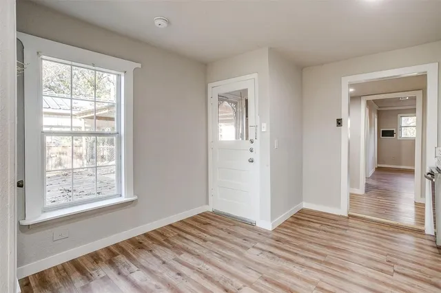 a view of a room with wooden floor and window