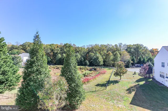 a view of a house with a yard and sitting area