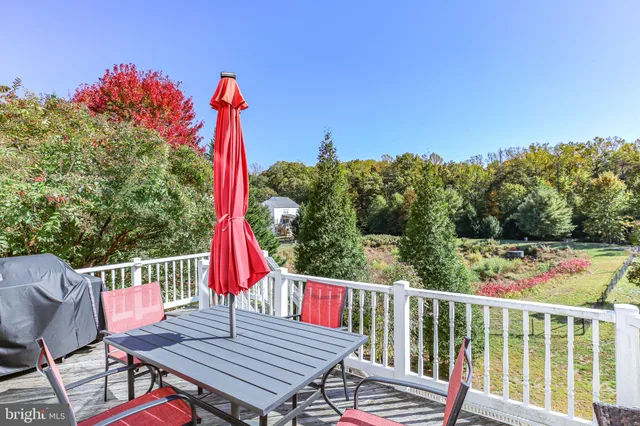 a view of a wooden chairs and table in patio