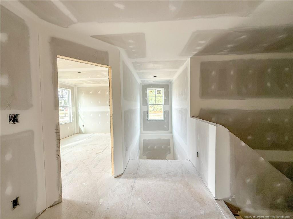 3318 S River Wade, NC 28395 - Photo 11 of 22 a view of a hallway with wooden floor and staircase