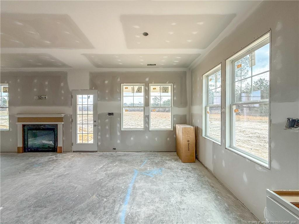 3318 S River Wade, NC 28395 - Photo 6 of 22 a view of an empty room with a fireplace and a window