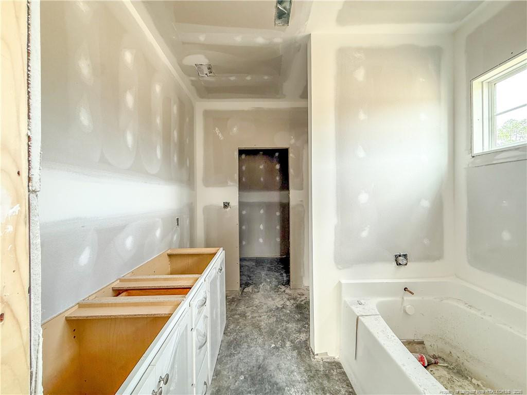 3318 S River Wade, NC 28395 - Photo 9 of 22 a bathroom with a bathtub and a shower