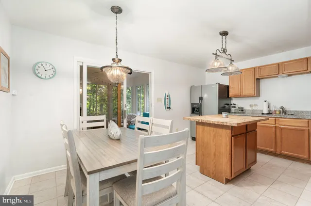 a kitchen with stainless steel appliances granite countertop a sink a stove and a wooden floors